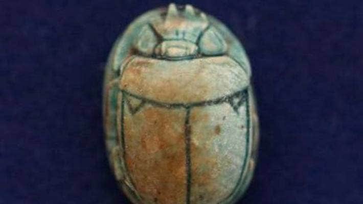 An Egyptian pharaonic scarab is pictured at the site of one of dozen newly discovered ancient Egyptian cemeteries dating back to the New Kingdom era.